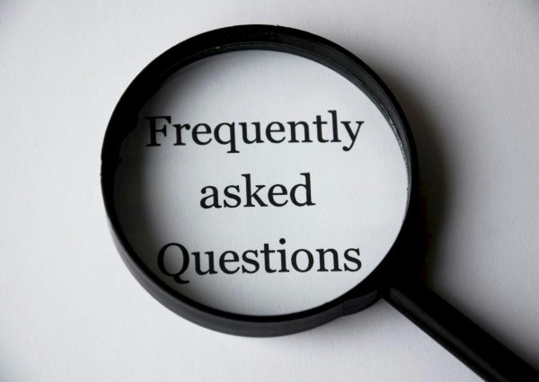 pexels-photo-221164-221164 Close-up of a magnifying glass focusing on the phrase 'Frequently Asked Questions'.